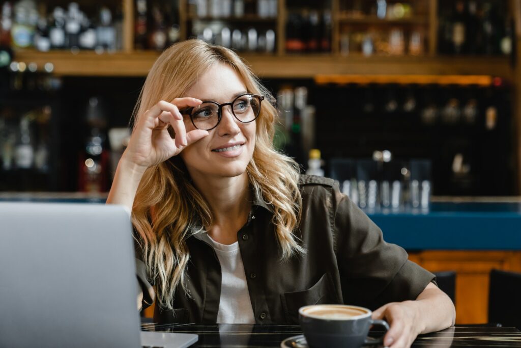 Tutor self-employed working remotely on laptop, e-commerce, work break in cafe